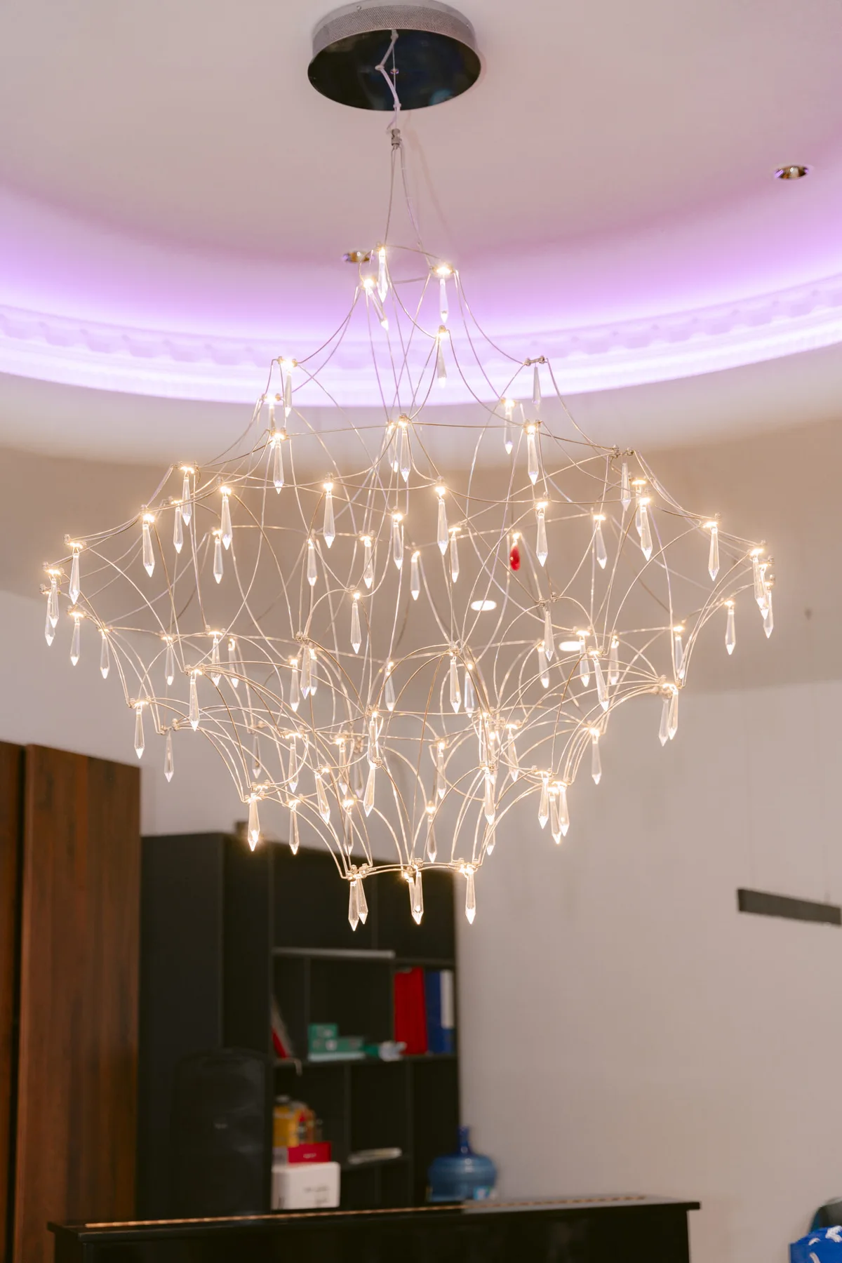 The multi-tier crystal pendant — the space's focal point