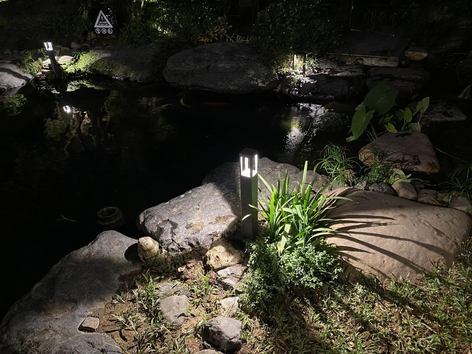 Garden lights on stone and trees, keeping the dark for quiet