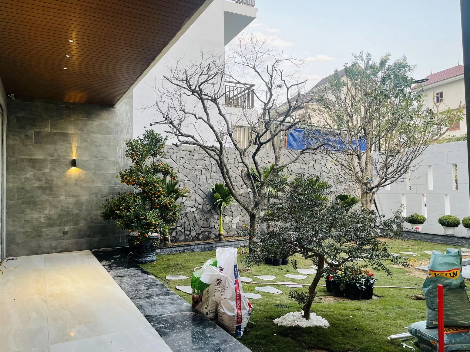 The courtyard with ornamental trees and a stone wall