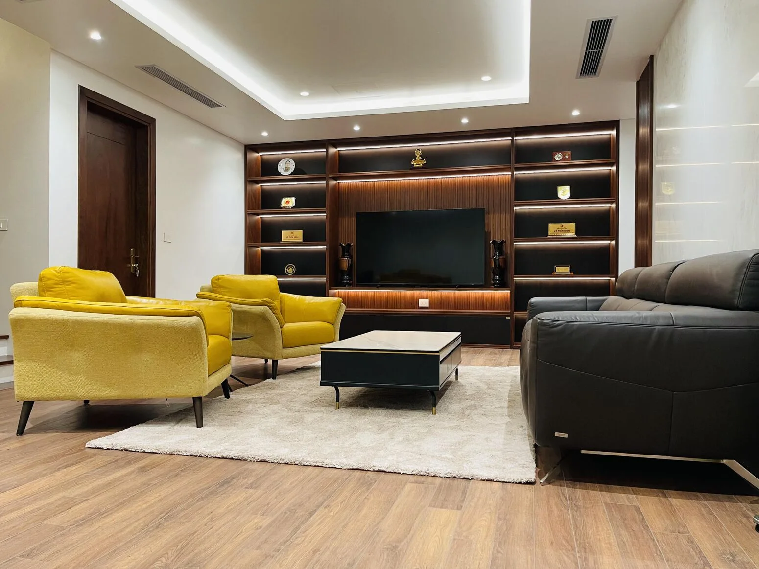 Living nook — yellow chair and wood-panelled wall