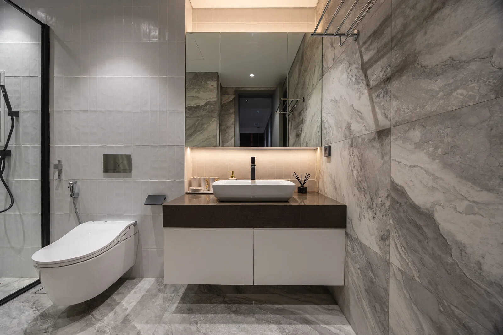 The stone bathroom — lit mirror and vanity