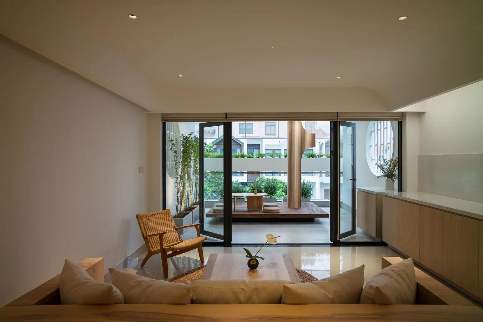 The living room opening to the yard, wood and natural light