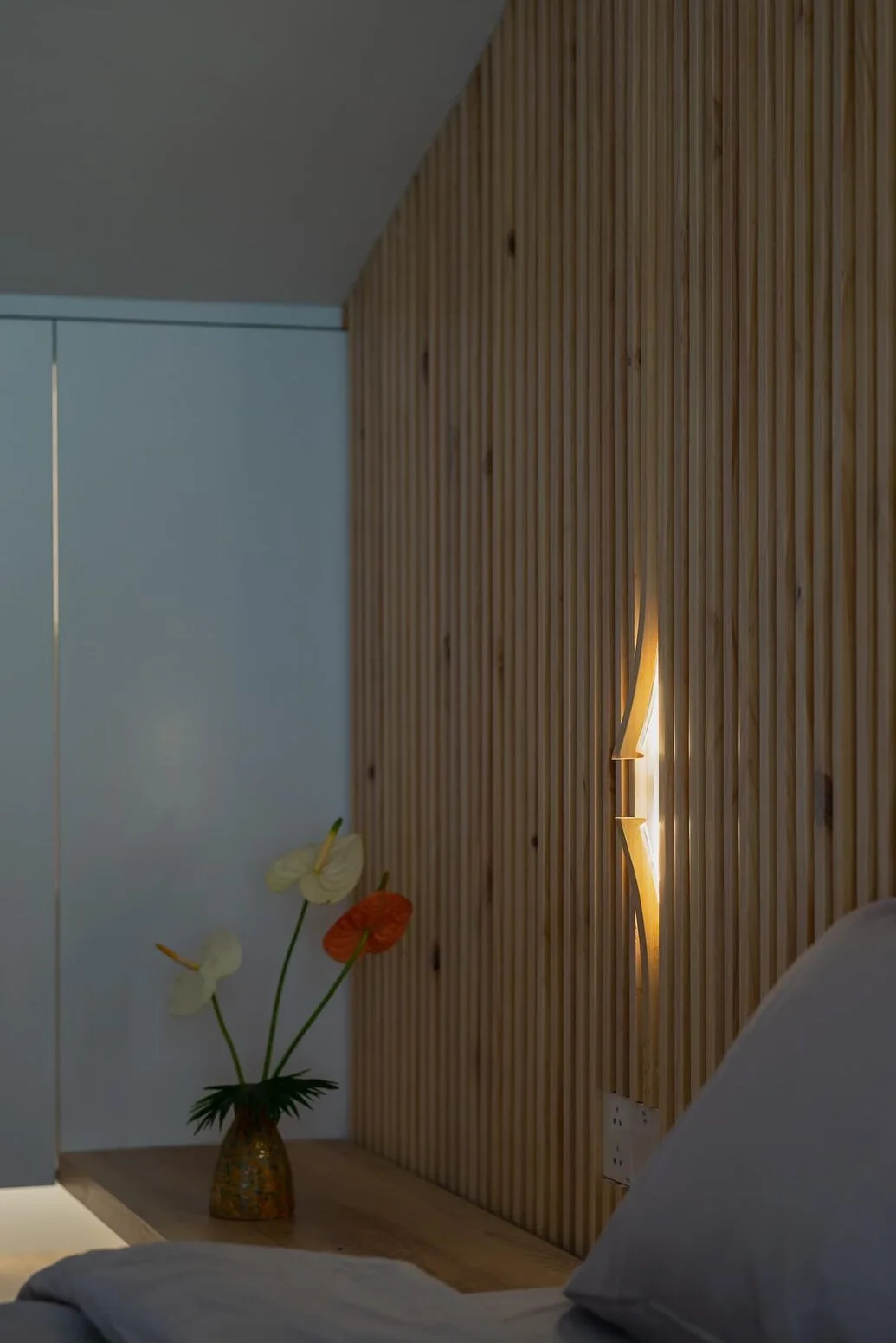 A trace of light on the timber louver wall