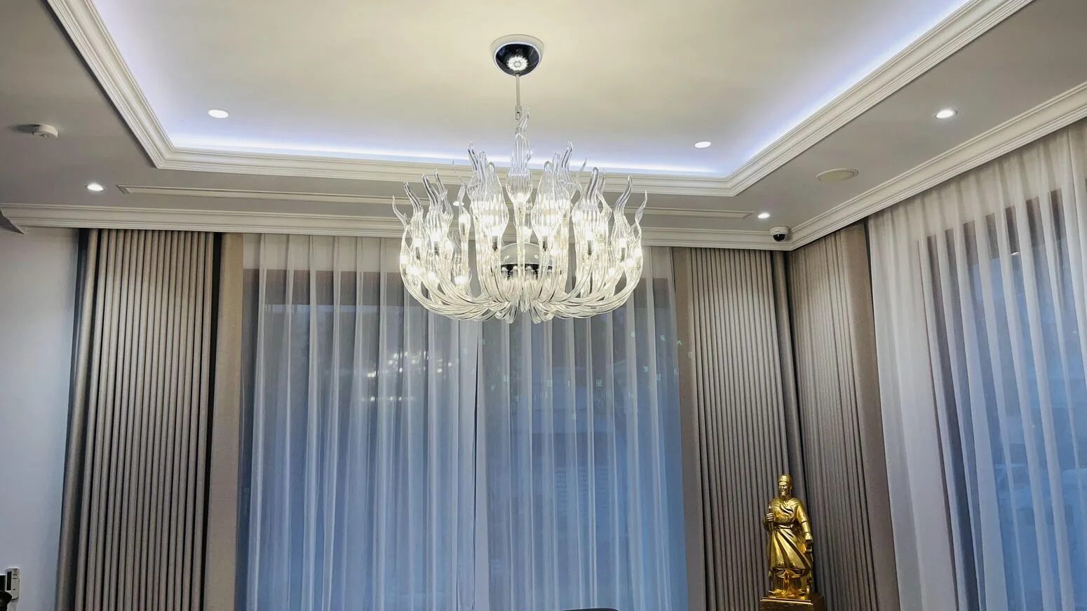 The finished crystal chandelier beside the curtains