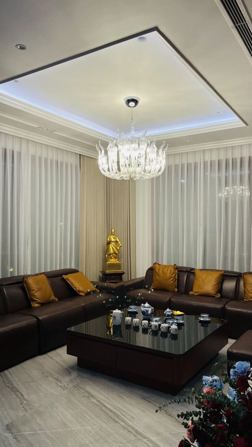 Living room — crystal chandelier and leather sofa