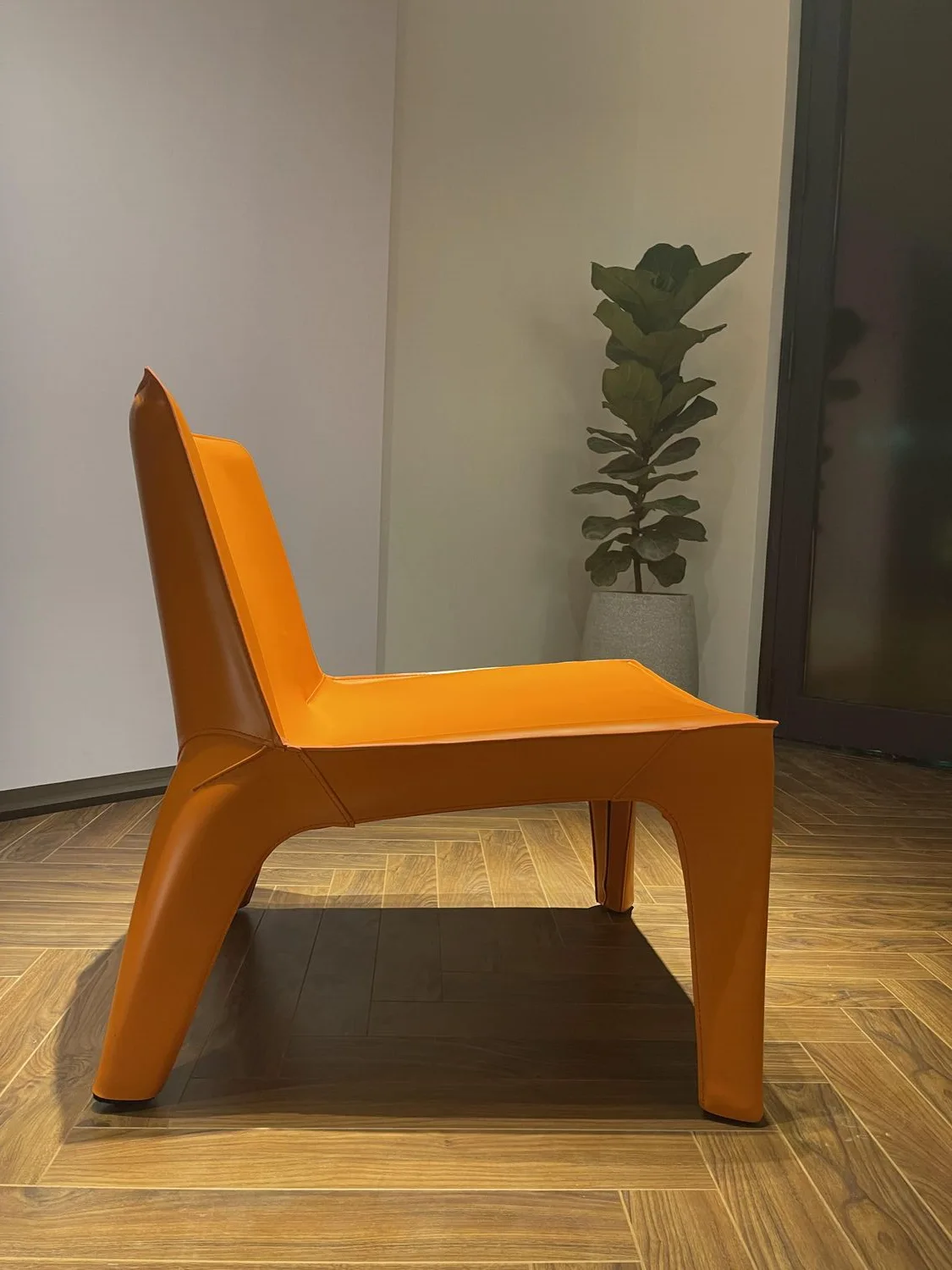 Detail of the designer chair by the wood panel