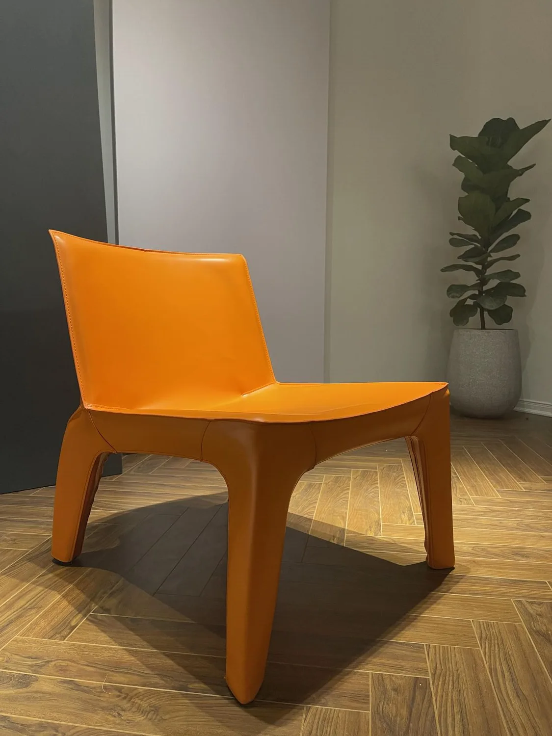 A designer chair displayed by the wall