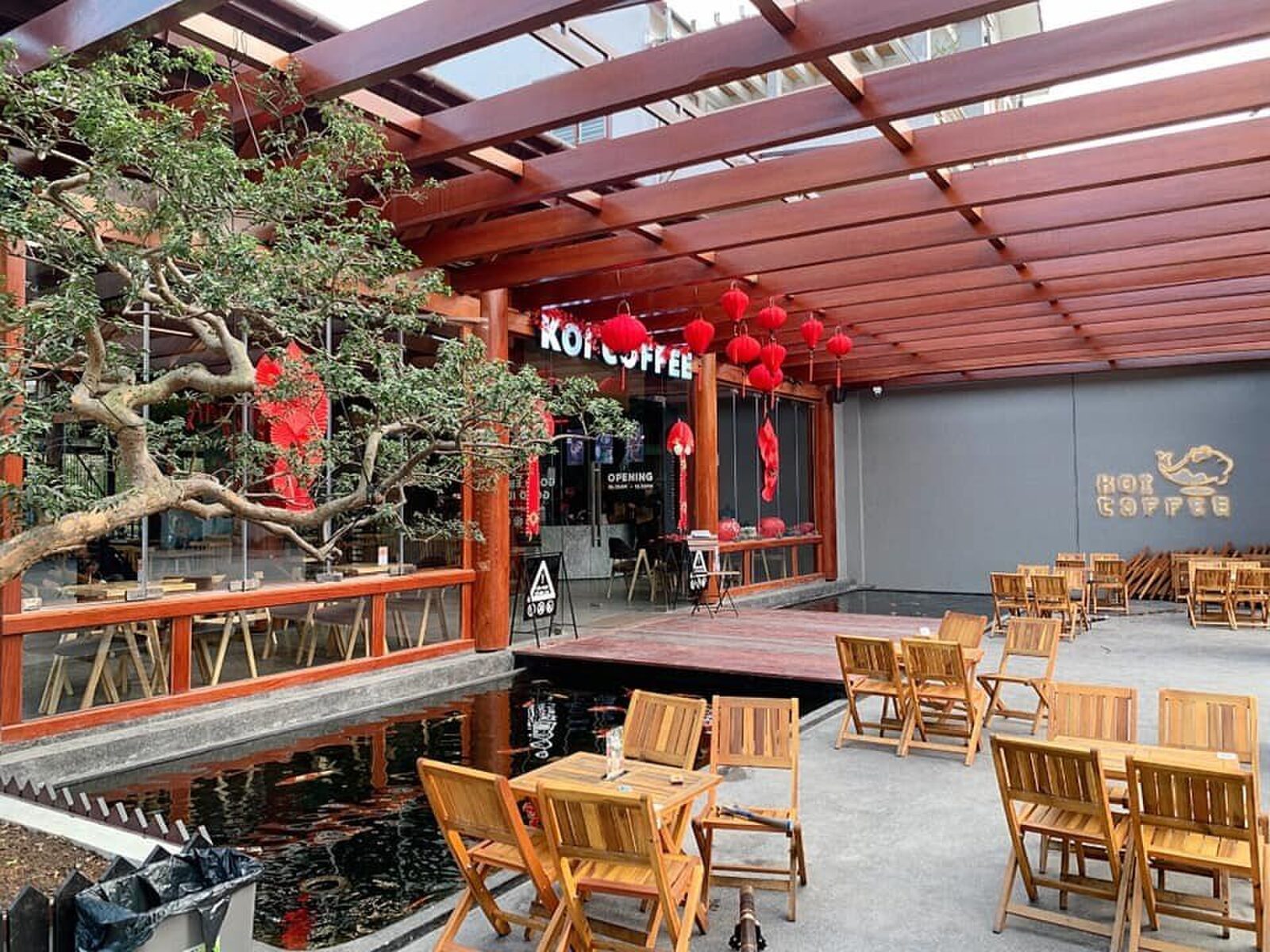 Không gian ngồi trong nhà — bàn gỗ, đèn lồng đỏ